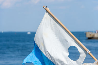 Close-up of sailboat against sea