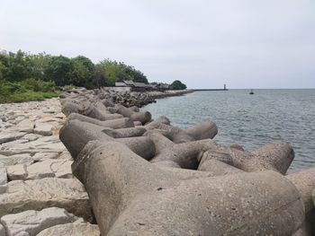 Rocks on beach against sky