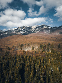 Scenic view of snowcapped mountains against cloudy sky