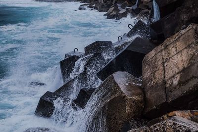 High angle view of rocks in sea against sky