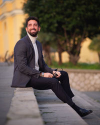 Portrait of young man sitting outdoors