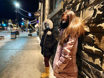 Woman standing on street in city