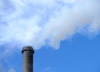 Low angle view of smoke stack against sky