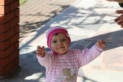 Portrait of baby girl on footpath