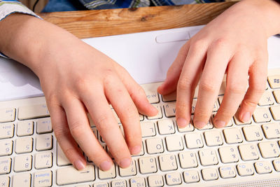 Midsection of woman using smart phone on table