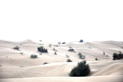 Road by landscape against clear sky