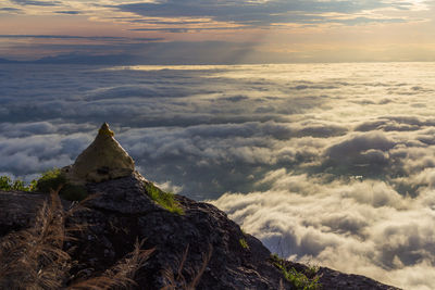 Scenic view of rock against sky during sunset