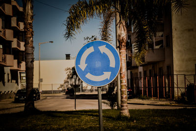 Road sign against trees