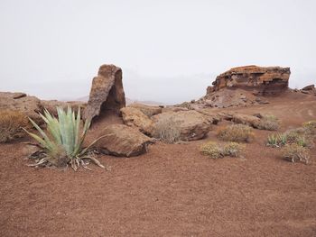 Scenic view of rocks against clear sky