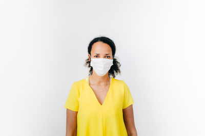 Portrait of black woman with surgical mask against white background