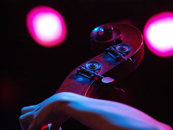 Close-up of hand holding illuminated lighting equipment