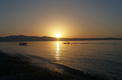 Scenic view of sea against clear sky during sunset