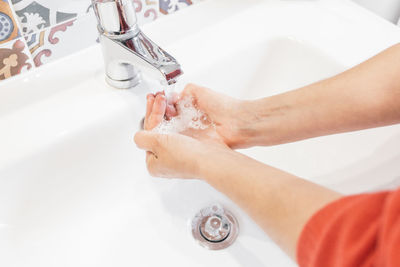 High angle view of hands in bathroom