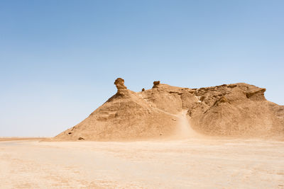 Scenic view of desert against clear sky