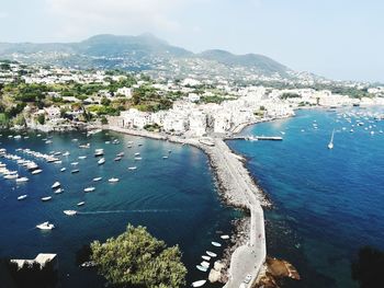 High angle view of sea and cityscape against sky