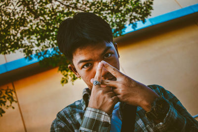 Portrait of young man holding camera