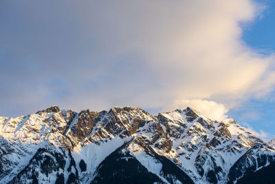 The sun sets on iconic mount currie still covered in snow on a spring day in the coast mountains of british columbia.