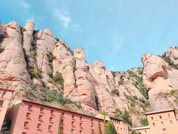 Low angle view of rocks on mountain against sky