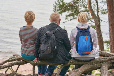 Rear view of people walking on shore