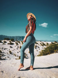 Full length of woman standing against sky