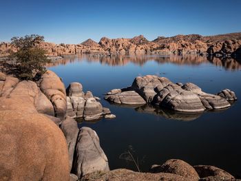 Scenic view of lake against clear blue sky