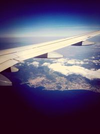 Cropped image of airplane flying over landscape