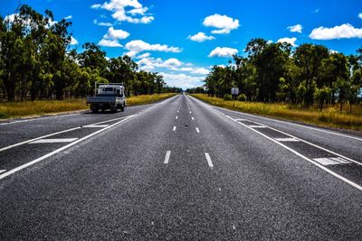 Car on highway against blue sky