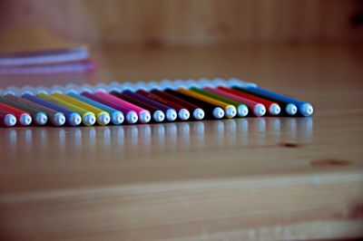 Close-up of multi colored pencils on table