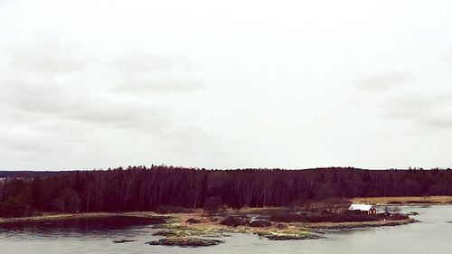 Scenic view of river against cloudy sky