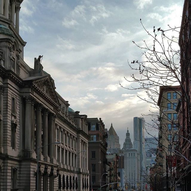 architecture, building exterior, built structure, sky, city, low angle view, cloud - sky, building, bare tree, cloud, capital cities, cloudy, city life, residential building, travel destinations, modern, tree, day, outdoors, office building