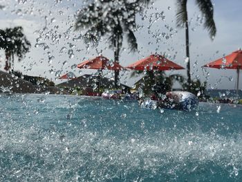 Wet street amidst buildings in city