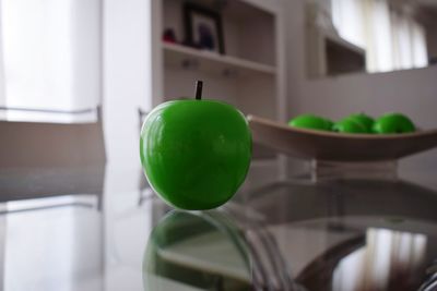 Close-up of artificial apple on table at home