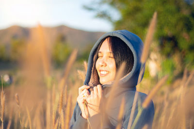 Smiling woman with eyes closed