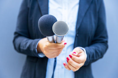Female reporter holding microphone during media interview. freedom of the media concept.