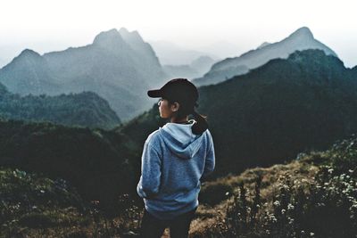 Full length of man standing on mountain against sky