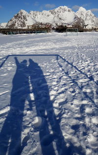 Shadow of person on snow covered field