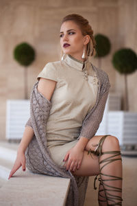 Beautiful young woman sitting at home
