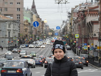 Portrait of girl standing on city street