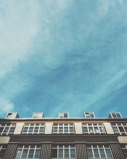 Low angle view of building against cloudy sky