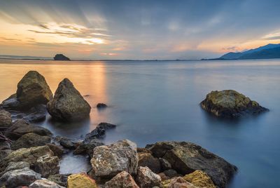 Scenic view of sea against sky at sunset