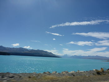 Scenic view of sea and mountains against sky