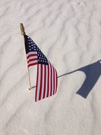 Close-up of flag on sand