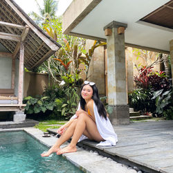 Portrait of woman sitting in swimming pool