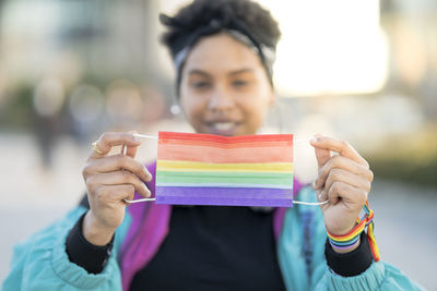 Portrait of woman with multi colored holding umbrella