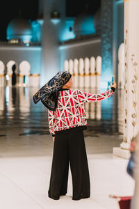 Woman taking selfie while standing on floor