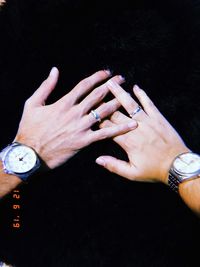 Midsection of woman hand against black background