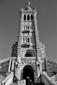 Low angle view of bell tower against sky