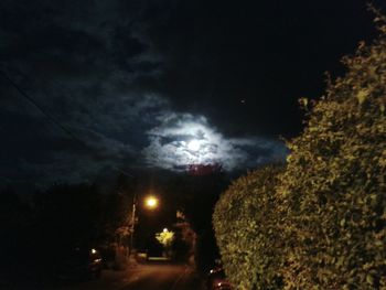 Road against cloudy sky at night