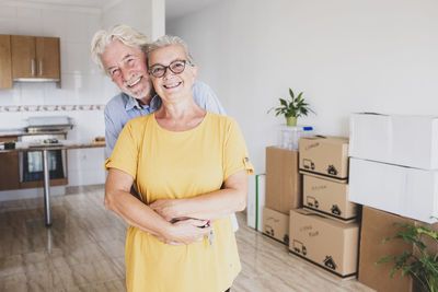 Portrait of smiling senior couple standing at home