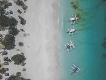 Directly above shot of outrigger canoes on shore at beach